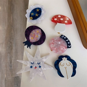 Artistic acetate hair clip set featuring mushroom star and moon designs with marble textures