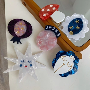 Artistic acetate hair clips featuring mushroom, star, and abstract female silhouette shapes