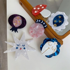 Set of 6 colorful handmade acetate hair clips featuring planet and mushroom designs