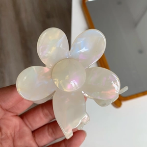 Detailed view of the pink iridescent flower hair claw clip with a glossy finish