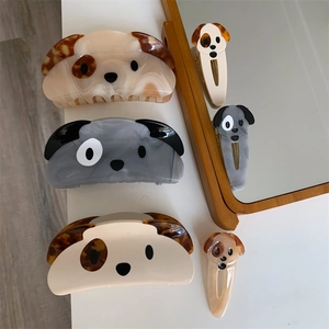 Detailed view of acetic acid puppy hair clips and duckbill clamps in cream and grey