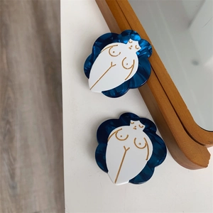 Artistic acetate hair clip with deep blue base and white female silhouette relief art