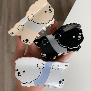 Set de tres pinzas para el cabello con forma de perro en acetato crema, negro y blanco