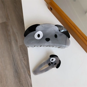 Detail view of acetate dog hair claw and clip set with grey marble texture and cute design