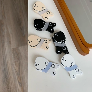 Detail view of cute cartoon dog hair clips in white, beige, and black acrylic sets