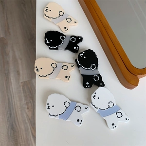 Detailed view of cute acrylic Bichon dog hair clips in white, beige and black colors