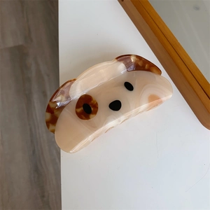 Detailed view of squinting dog hair claw clip made from premium marbled acetate resin