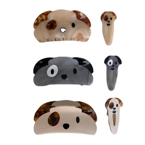 Set of three acetate dog-shaped hair claw clips and snap clips with marbled patterns