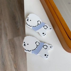 Detail of two cute white Bichon Frise dog hair clips made of high-quality acrylic material