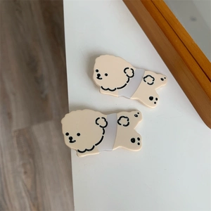 Close-up of cute cartoon dog pattern on cream beige acetate hair clips for women and kids
