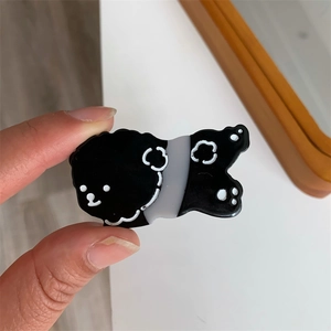 Detailed view of a cute cartoon puppy hair clip made of polished acrylic material