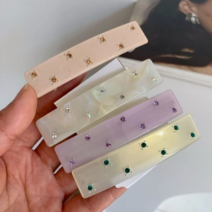 Handheld set of four square geometric acetate hair clips with inlaid colorful rhinestones