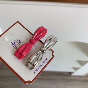 Lot de deux barrettes à cheveux nœud en argent métallique et rose vif sur carte