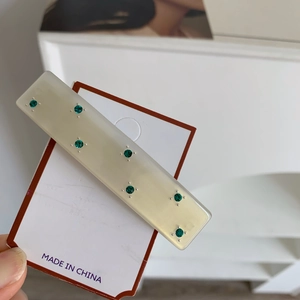 Rectangle cream acetate hair clip with emerald green rhinestones and silver accents