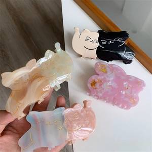 Detailed close-up showing various colors of the acetate cartoon cat hair claw clips