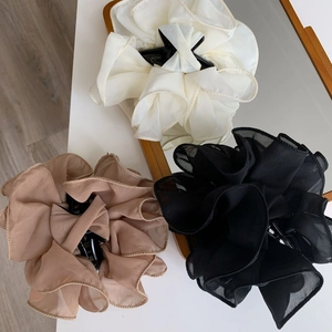 Three elegant chiffon flower hair claws in cream, black, and mocha brown colors