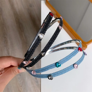 Detail of double-layer denim headband featuring colorful heart-shaped rhinestones