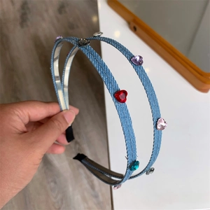 Detailed close-up of double-layer denim headband with multi-colored heart rhinestones