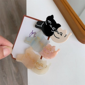 Cute cat-shaped hair clips set in marble and pastel colors with gold feline details