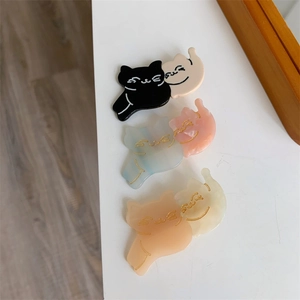 Detailed view of three pairs of cute acetate cat hair clips in soft pastel colors