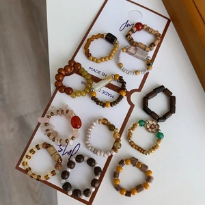 Détail d'un lot de 11 bagues élastiques faites main avec perles en bois et pierre naturelle