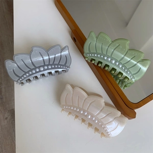 Three-color acetate hair claws in blue, green, and cream with pearl accents for women