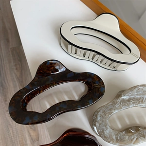 Detail view of large acetic acid hair claws with tortoise and marble patterns