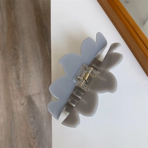 Close-up of lotus petal hair claw clip with frosted texture and gold spring mechanism