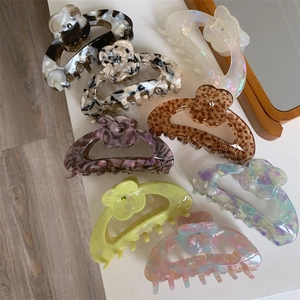 Detail view of colorful floral hair claws in marble and tortoiseshell patterns