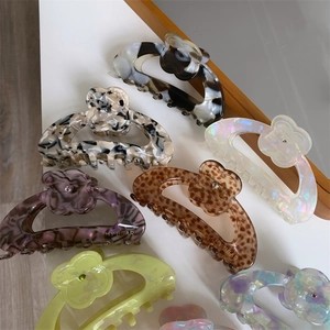 Close-up of acetic acid hair clips in marble and leopard patterns with floral details