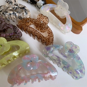 Floral acetic acid hair claw clips with central rhinestones and shiny finish