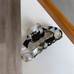 Detailed view of large acetate flower hair claw clip with brown tortoiseshell patterns