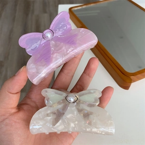 Elegant purple marble bow hair claw with pearl detail and premium acetate finish