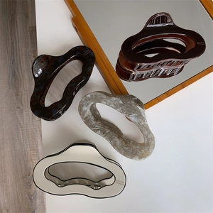 Selection of acetate hair claws in tortoise shell, amber, and marble patterns