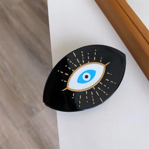 Pinza per capelli moderna Evil Eye nera con raggi dorati e iride blu per donna