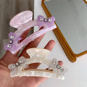 Elegant purple and white acetate bow hair claws with sparkling rhinestones for women