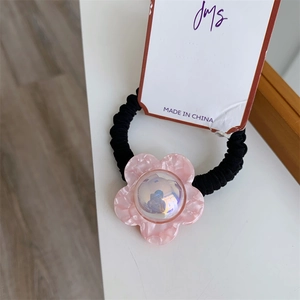 Elegant elastic hair tie with pink resin flower and iridescent center on display card