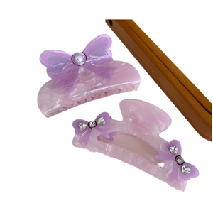 Elegant purple acetic acid bow hair claw clips with pearls and rhinestones on white background