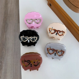 Vue détaillée de cinq pinces à cheveux chien colorées avec lunettes cœur léopard