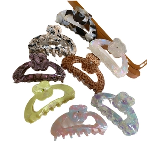 Medium acetate flower hair claws in multiple colors including marble and tortoiseshell
