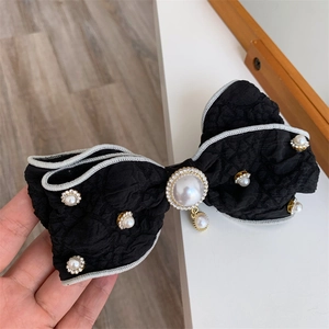 Elegant black bow hair clip with jacquard texture, pearls and rhinestone details