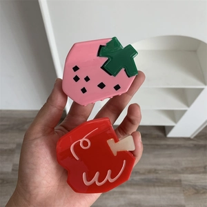 Cute fruit-shaped hair claws featuring strawberry and red apple designs in resin material