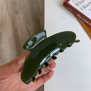 Classic deep green acetate hair claw clip with glossy finish for long hair styling