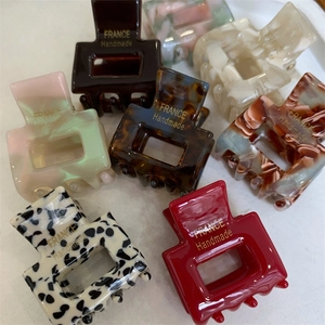 Detailed view of handmade geometric square hair claws in seven assorted resin patterns
