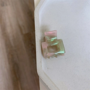 Detail showing the pink and green marbled acetate texture and France Handmade logo