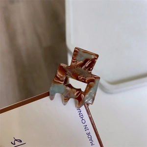 Macro detail of tortoiseshell resin hair claw with golden France Handmade lettering