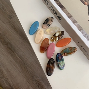Detailed set of acetate oval hair clips with various marble and tortoiseshell patterns