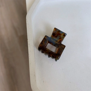 Detail of tortoise shell hair claw clip with golden France Handmade lettering