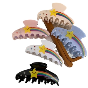 Five colorful star and rainbow claw hair clips for women in diverse acrylic shades