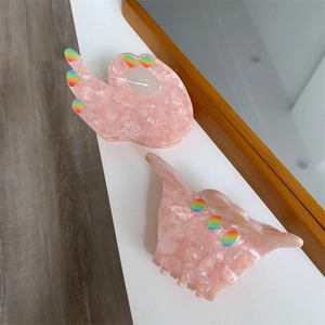 Pink acetate claw clips set in OK and Shaka hand signs with rainbow nails detail